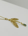 Image is a golden dragonfly woman and tourmaline pendant with a fancy chain necklace, handmade by Izaskun Zabala.