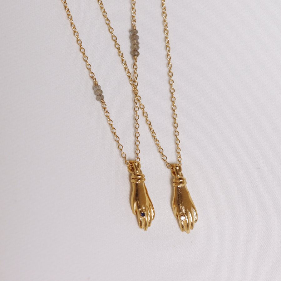 Image is a set of gold plated hand pendant necklaces with stone ring, handmade by Izaskun Zabala.
