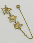 Gold-plated floral single earring, handmade by Izaskun Zabala, with a light gray background.