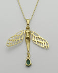 Image is the back of a golden dragonfly woman and tourmaline pendant with a fancy chain necklace, handmade by Izaskun Zabala.