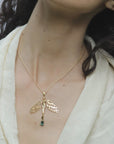 Image is a 24K gold plated dragonfly woman and tourmaline pendant with a fancy chain necklace on model, handmade by Izaskun Zabala.