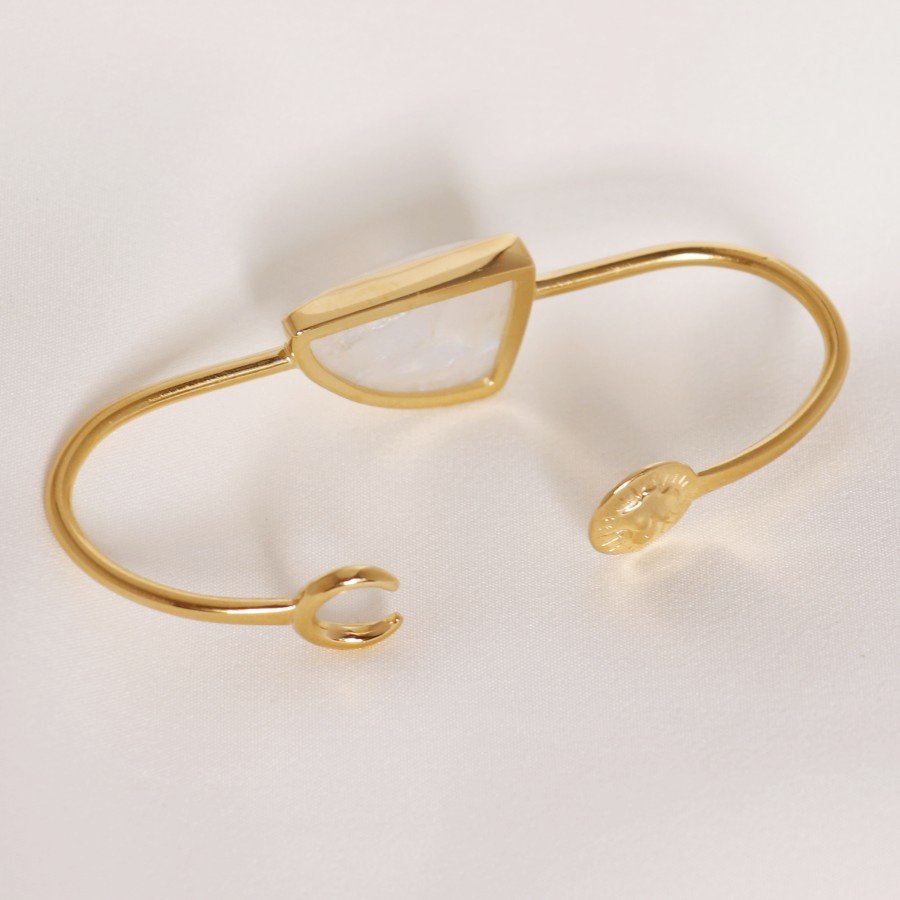 Image is a 24K gold plated palm cuff with an asymmetrical moonstone cabochon, handmade by Izaskun  Zabala.
