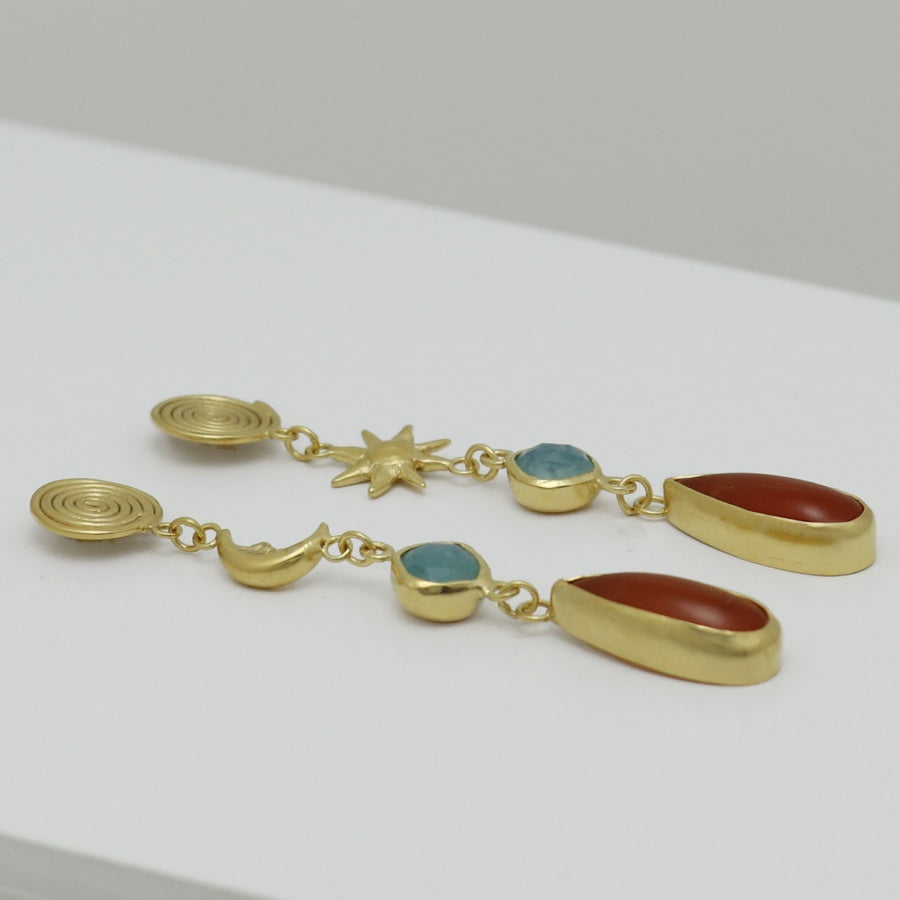 Image is a pair of 24K gold plated drop earrings with spiral stud, celestial motifs, chalcedony and carnelian gemstones, handmade by Izaskun Zabala.