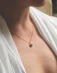 Image is a gold filled chain necklace with a cushion cut stone, handmade by Izaskun Zabala.