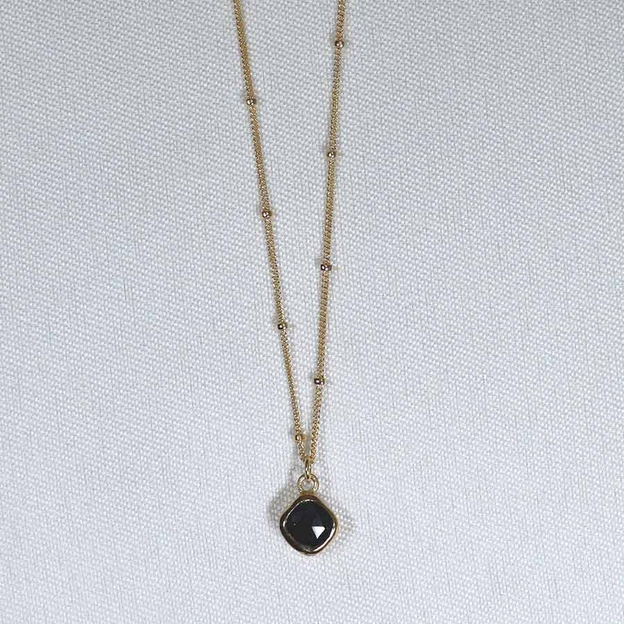 Image is a gold filled chain necklace with a cushion cut stone, handmade by Izaskun Zabala.