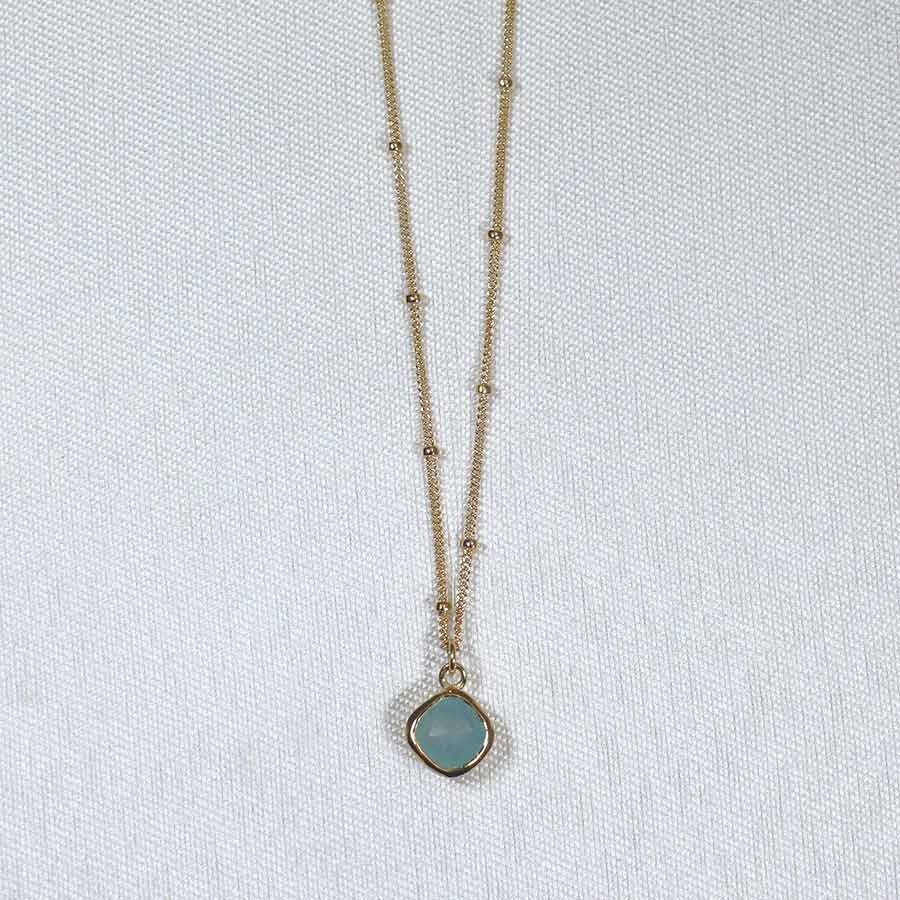 Image is a gold filled chain necklace with a cushion cut stone, handmade by Izaskun Zabala.