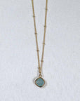 Image is a gold filled chain necklace with a cushion cut stone, handmade by Izaskun Zabala.