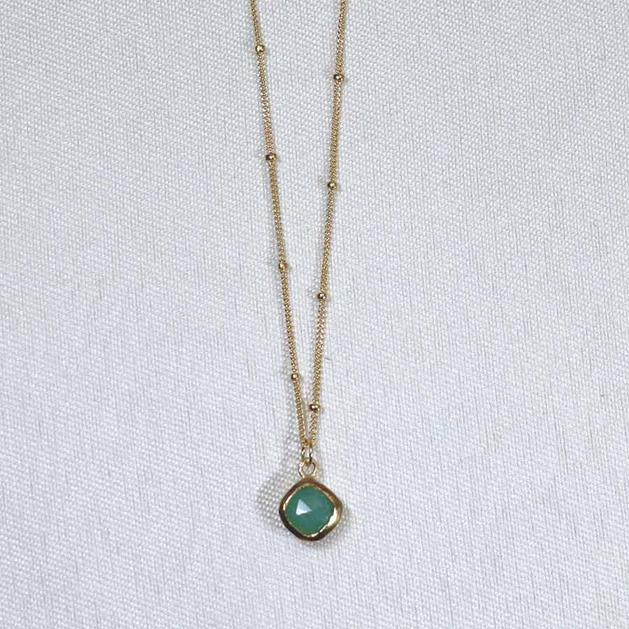 Image is a gold filled chain necklace with a cushion cut stone, handmade by Izaskun Zabala.