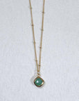 Image is a gold filled chain necklace with a cushion cut stone, handmade by Izaskun Zabala.