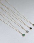 Image is a set of gold filled chain necklaces with a cushion cut stone, handmade by Izaskun Zabala.