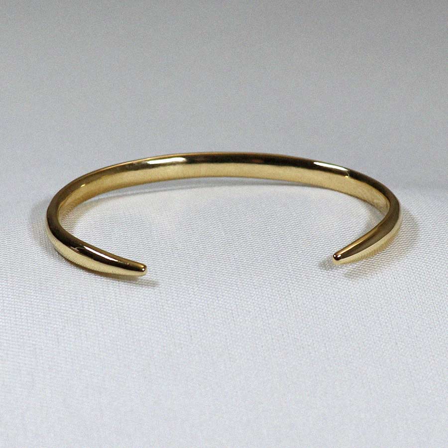 Image is an elegant 24K gold plated brass cuff, handmade by Izaskun Zabala.