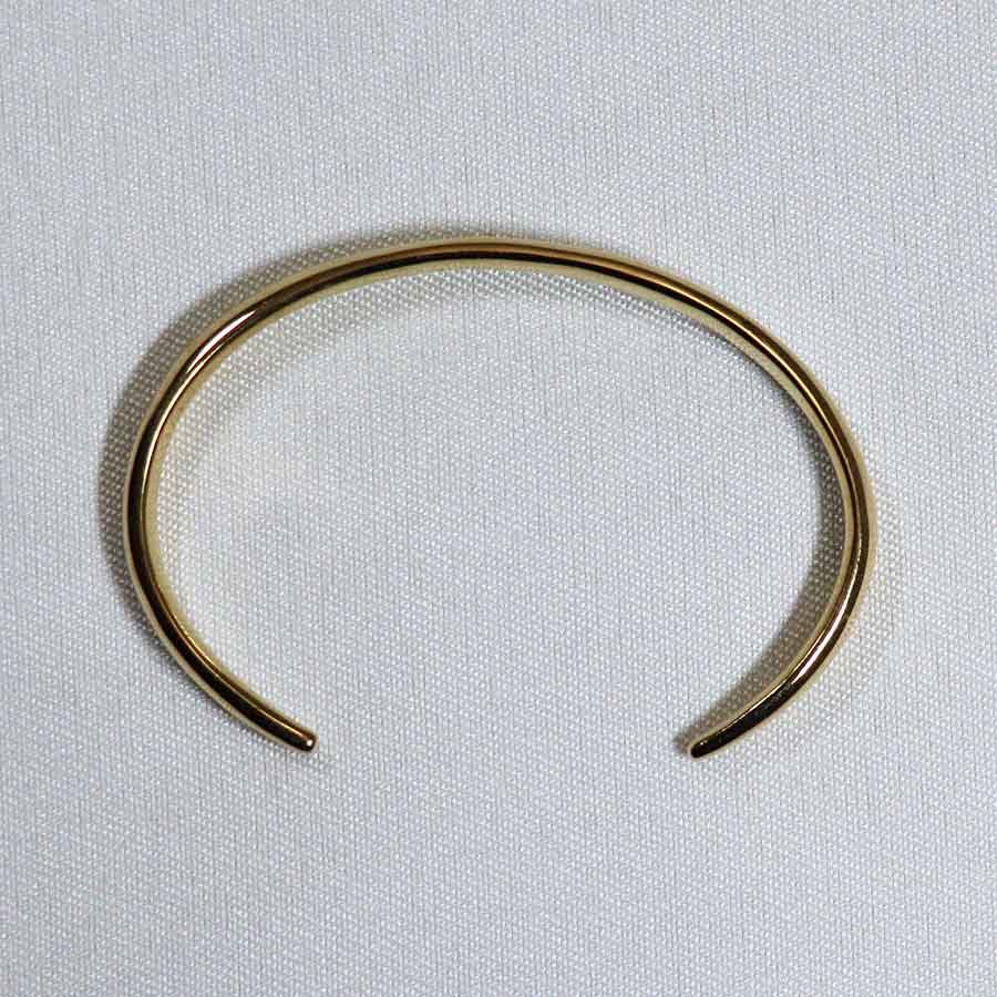 Image is an elegant 24K gold plated brass cuff, handmade by Izaskun Zabala.