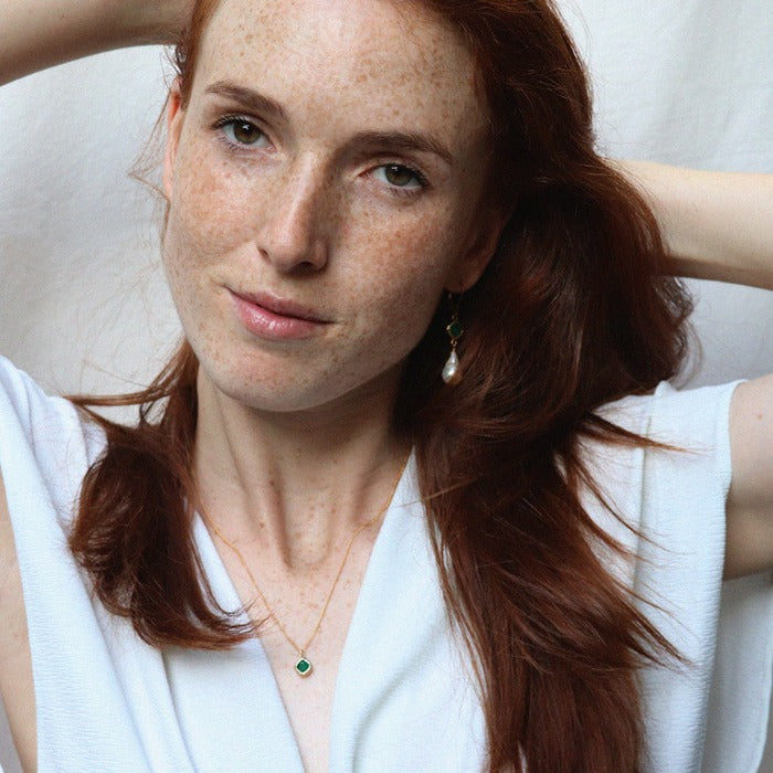 Image is a gold filled chain necklace with a cushion cut stone, handmade by Izaskun Zabala.