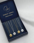 Image is gold-plated and silver birthstone medallion pendant delicate necklaces, displayed in the brand's packaging.