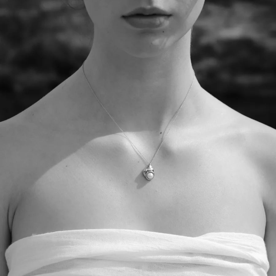 Shell-inspired Nerea Necklace featuring a button pearl styled on a model