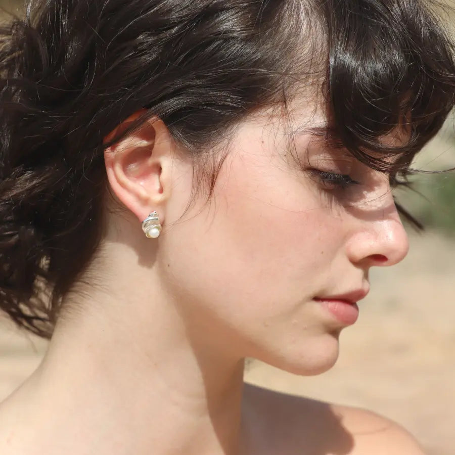 Sterling silver Nerea Earrings featuring round button pearls worn on a model