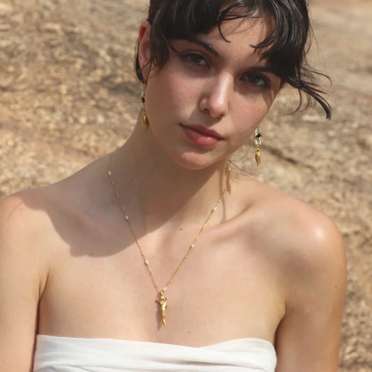 Gold-plated Sirena Necklace with pearl accents worn on a model