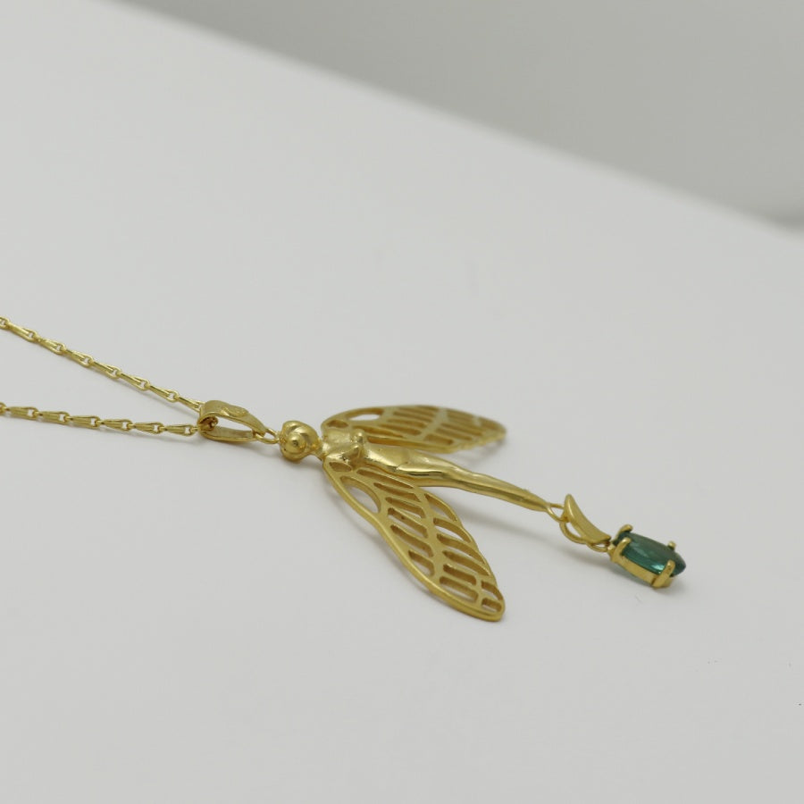 Image is a golden dragonfly woman and tourmaline pendant with a fancy chain necklace, handmade by Izaskun Zabala.