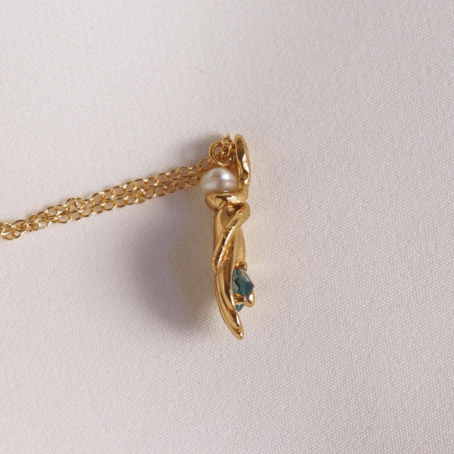 Image is a carved hand and snake pendant with topaz and pearl gold plated necklace, handmade by Izaskun Zabala.