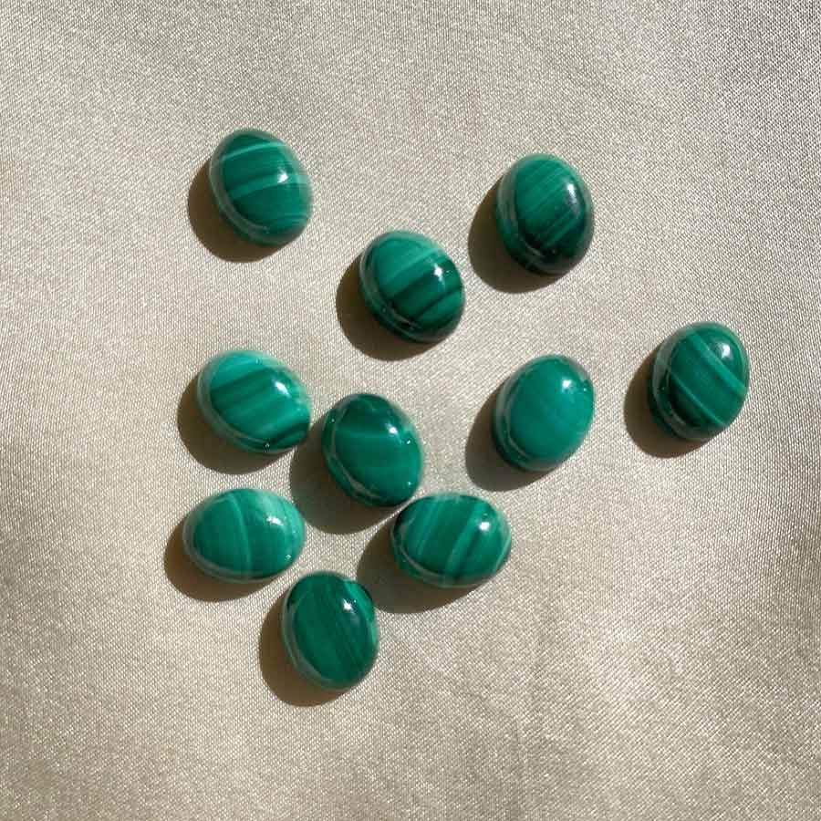 Image is a set of malaquite gemstone cabochons.