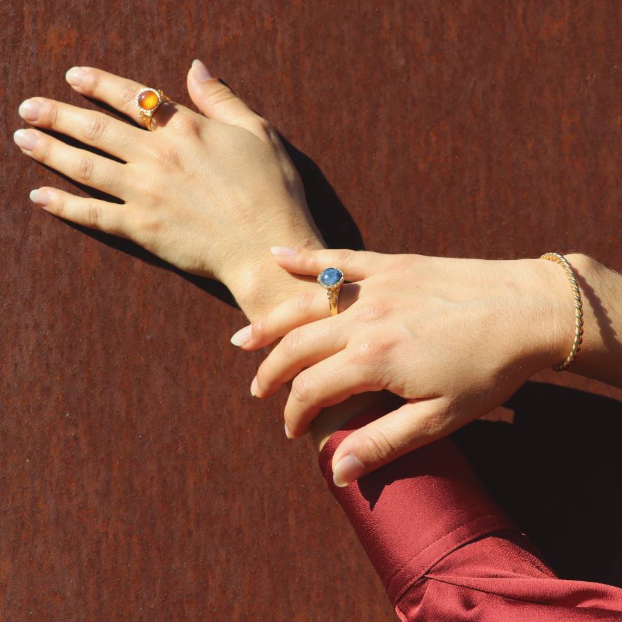Close-up of two hands with chalice alike cabochon rings, made by artisan Izaskun Zabala.