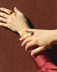 Close-up of two hands with chalice alike cabochon rings, made by artisan Izaskun Zabala.