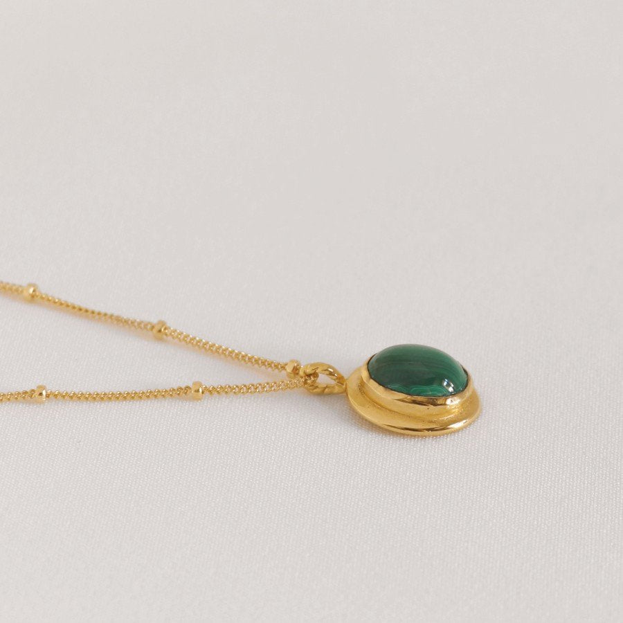 Image is a delicate 24K gold plated pendant with oval cabochon and gold filled chain, handmade by Izaskun Zabala.