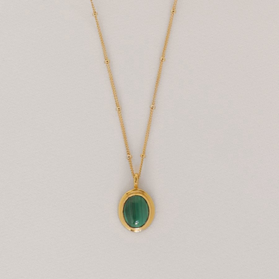 Image is a delicate 24K gold plated pendant with oval cabochon and gold filled chain, handmade by Izaskun Zabala.