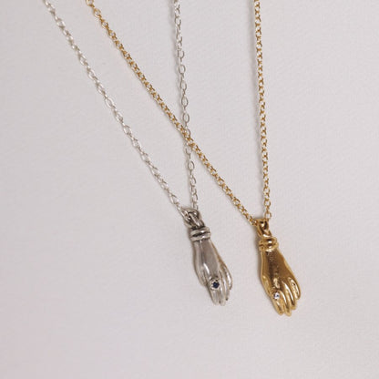 Image is a set of silver and gold plated hand pendant necklaces with stone ring, handmade by Izaskun Zabala.