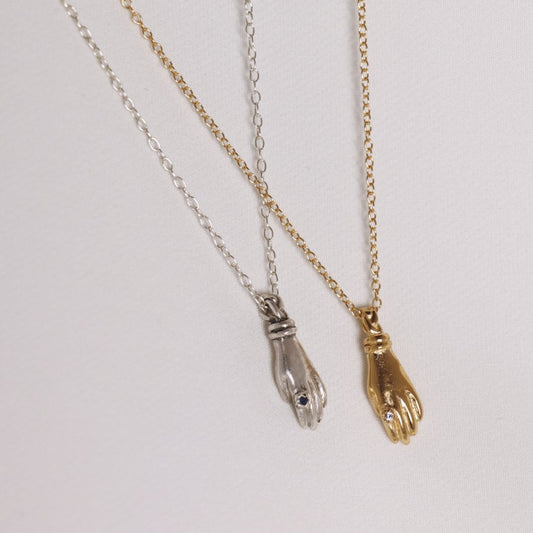 Image is a set of silver and gold plated hand pendant necklaces with stone ring, handmade by Izaskun Zabala.