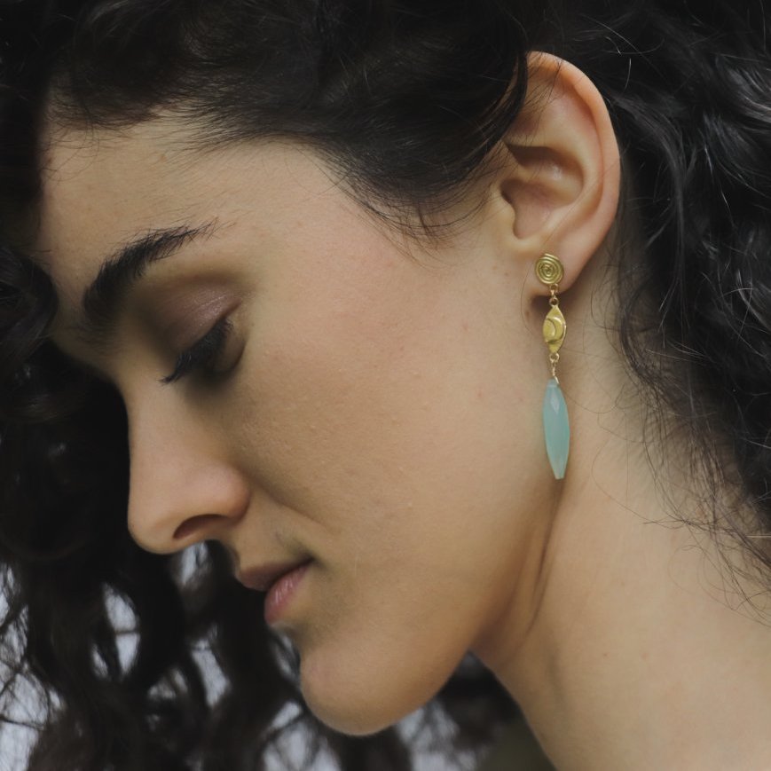 Image is a pair of 24K gold plated spiral stud and crescent moon, with chalcedony drop earrings on model, handmade by Izaskun Zabala.