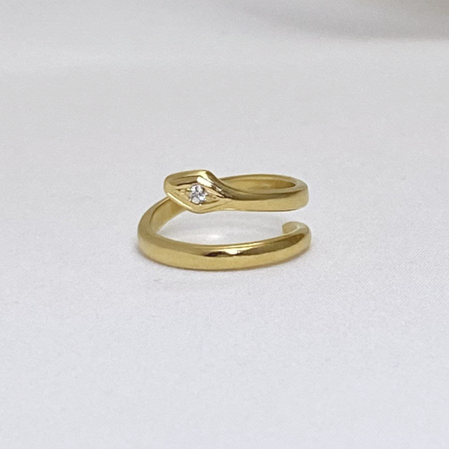 Image is a 24K gold plated minimalist snake rings with white sapphire, handmade by Izaskun Zabala.