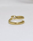 Image is a 24K gold plated minimalist snake rings with white sapphire, handmade by Izaskun Zabala.