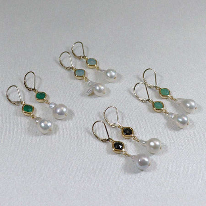 Image is a set of 24K gold plated earrings with a baroque pearl dangling from a cushion cut stone, handmade by Izaskun Zabala.