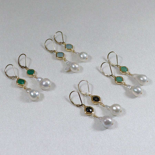 Image is a set of 24K gold plated earrings with a baroque pearl dangling from a cushion cut stone, handmade by Izaskun Zabala.