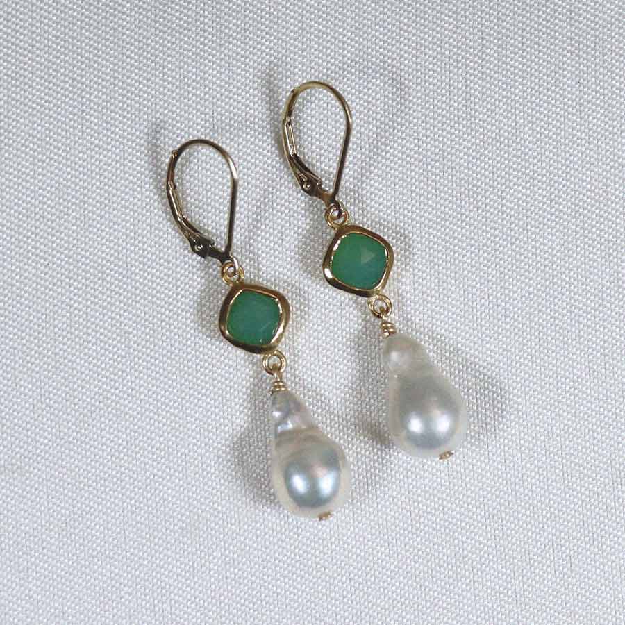 Image is a pair of 24K gold plated earrings with a baroque pearl dangling from a cushion cut stone, handmade by Izaskun Zabala.