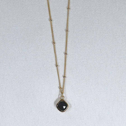 Image is a gold filled chain necklace with a cushion cut stone, handmade by Izaskun Zabala.