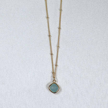 Image is a gold filled chain necklace with a cushion cut stone, handmade by Izaskun Zabala.
