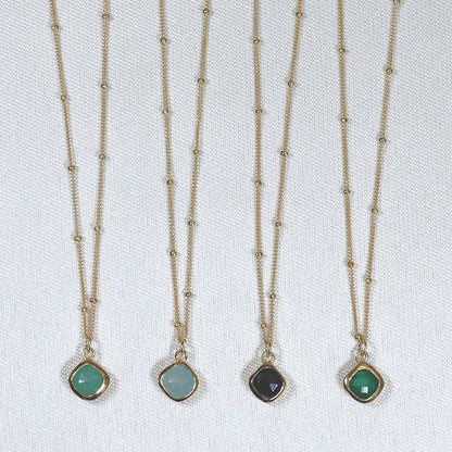 Image is a set of gold filled chain necklaces with a cushion cut stone, handmade by Izaskun Zabala.