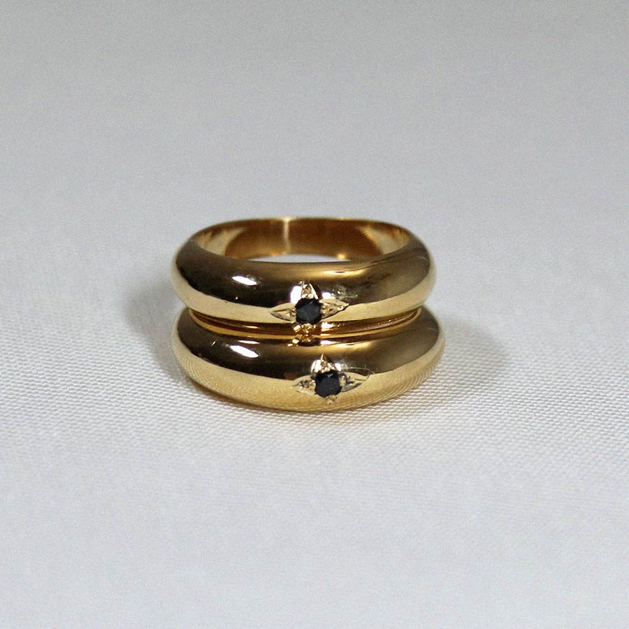 Image is a domed 24K gold plated band with a black spinel center stone set in an engraved star, handmade by Izaskun Zabala.