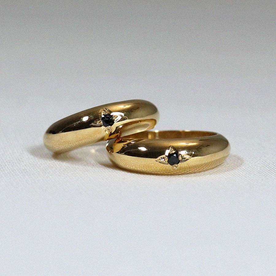 Image is a domed 24K gold plated band with a black spinel center stone set in an engraved star, handmade by Izaskun Zabala.