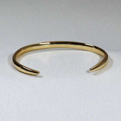 Image is an elegant 24K gold plated brass cuff, handmade by Izaskun Zabala.