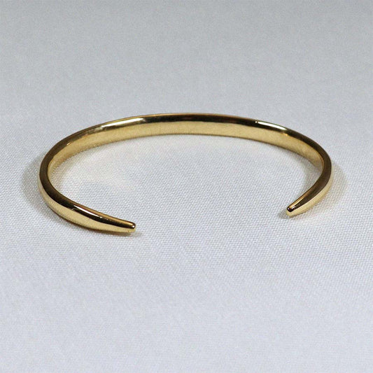 Image is an elegant 24K gold plated brass cuff, handmade by Izaskun Zabala.
