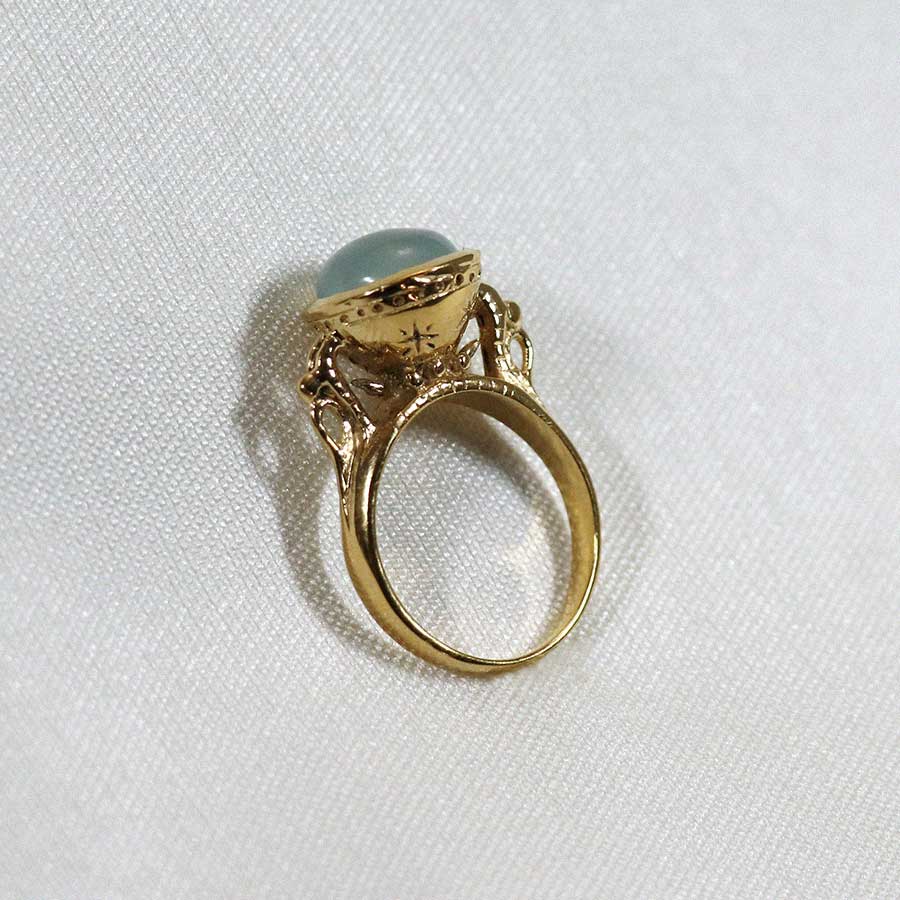 Image is a 24K gold plated statement ring with a 10mm chalcedony cabochon, handmade by Izaskun Zabala.