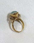 Image is a 24K gold plated statement ring with a 10mm chalcedony cabochon, handmade by Izaskun Zabala.