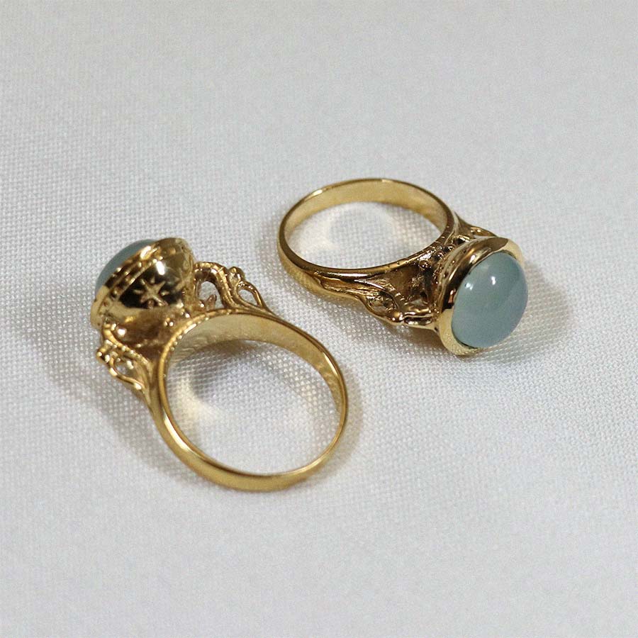 Image is a 24K gold plated statement ring with a 10mm chalcedony cabochon, handmade by Izaskun Zabala.