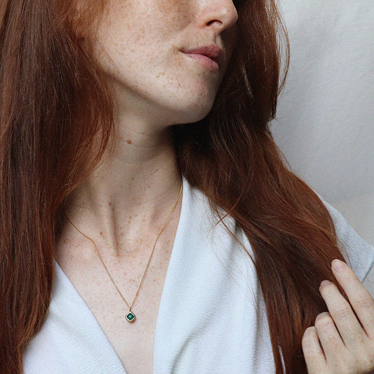 Image is a gold filled chain necklace with a cushion cut stone, handmade by Izaskun Zabala.