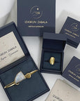 Image is Izaskun Zabala's branded dark blue with gold logo jewelry boxes.