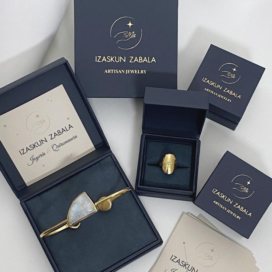 Image is Izaskun Zabala&#39;s branded dark blue with gold logo jewelry boxes.