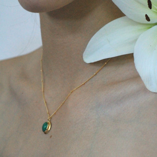 Image is a delicate 24K gold plated pendant with oval cabochon and gold filled chain, handmade by Izaskun Zabala.